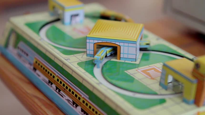 A toy train set rotates