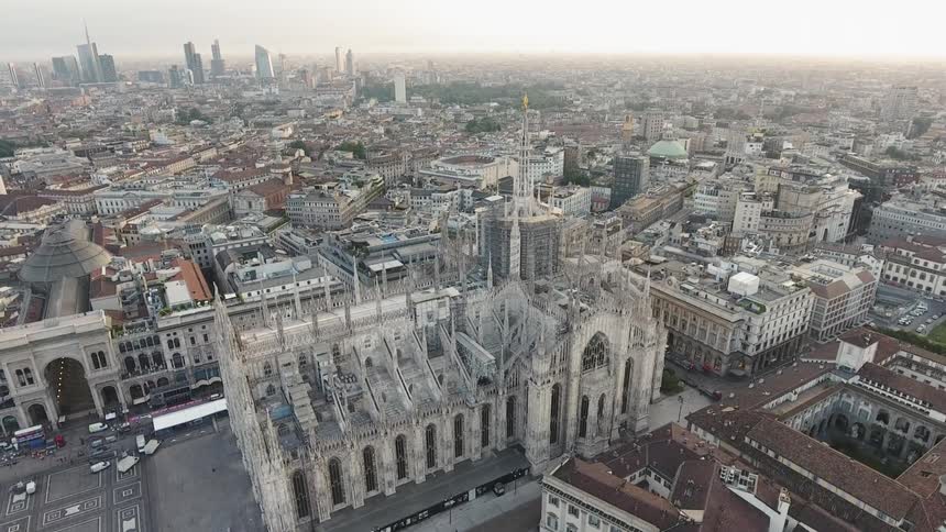 A cathedral sits in the middle of a city