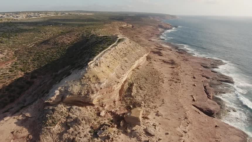 Large dirt hills near beach coast