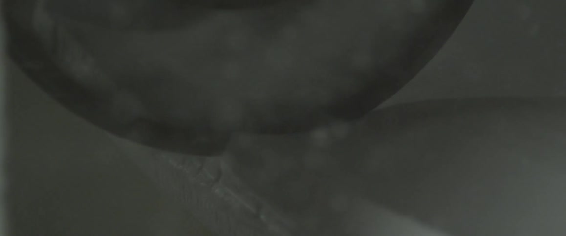 Specks move around in a fluid solution over an orb shaped object