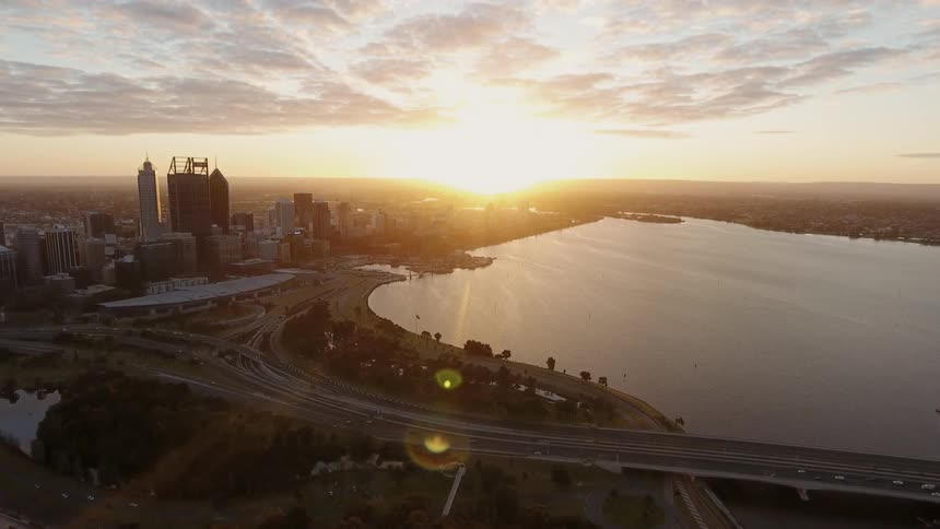 The sun sets over a city