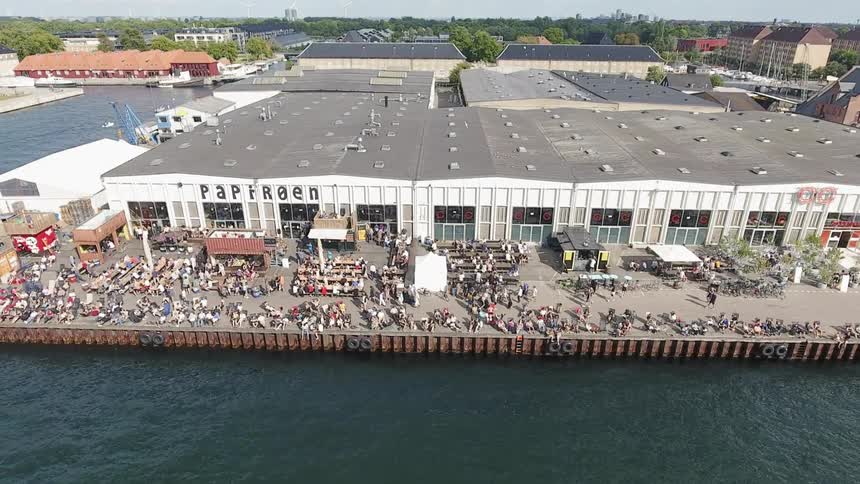 People at buildings near body of water