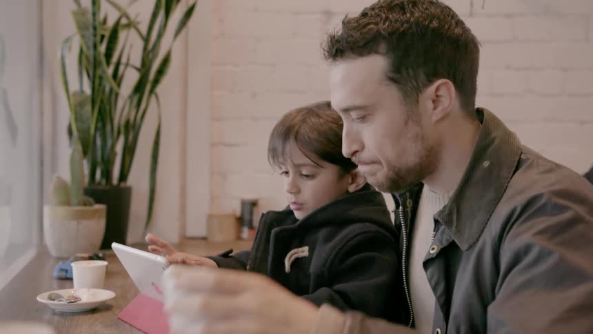 A man and child use a tablet together