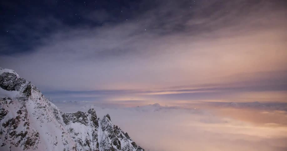 Time lapse of clouds below a mountain range