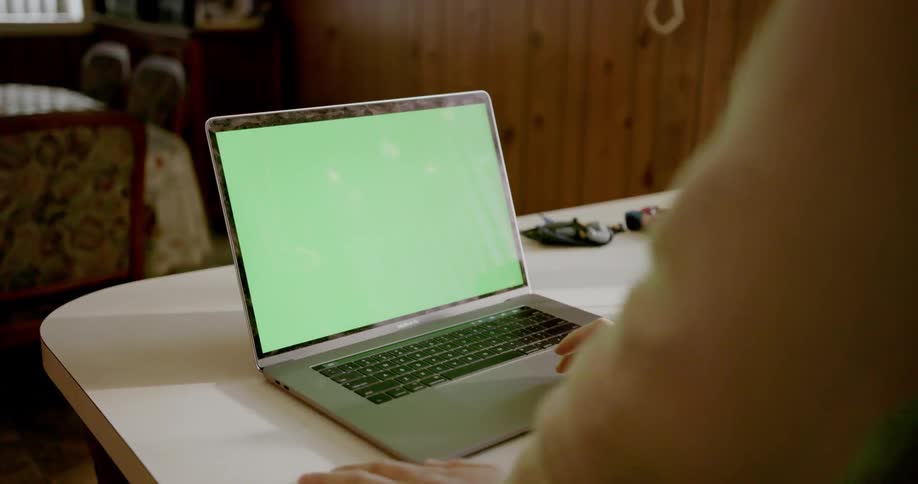 Person using laptop on kitchen counter