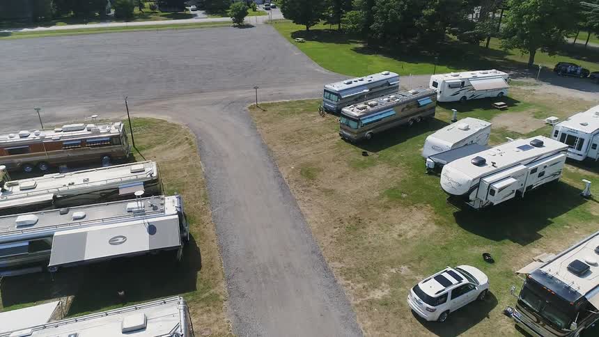 Campers sit parked in a campground lot