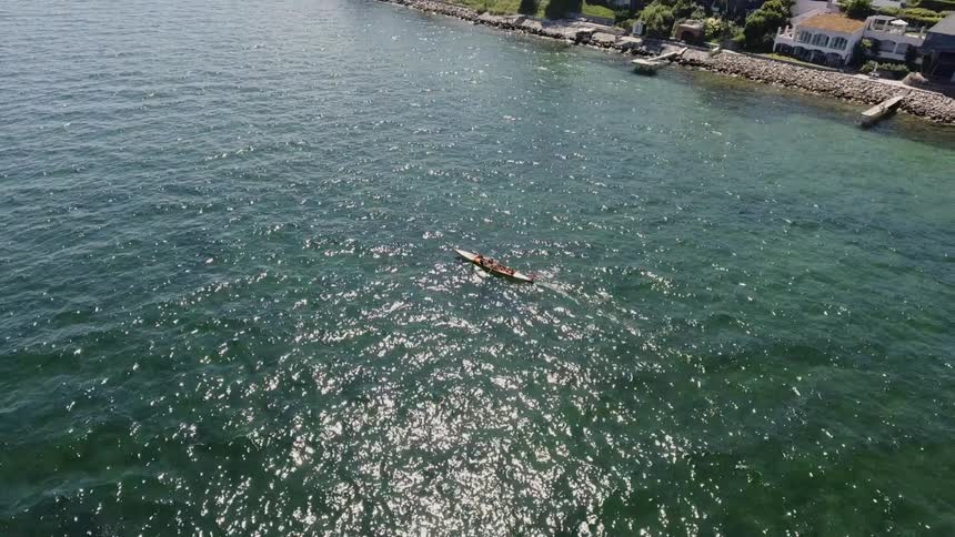 Row boat in the ocean off the coast