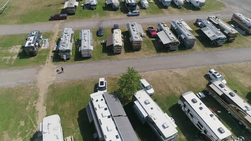 Campers and trailers are parked in a lot