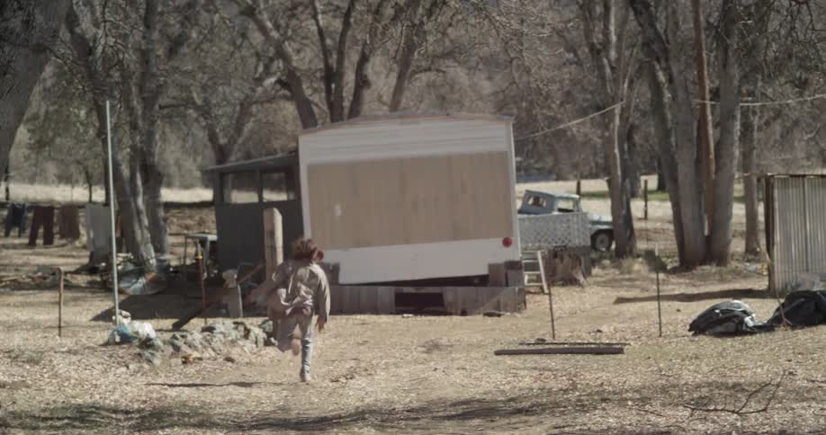 A man is running towards a pickup truck