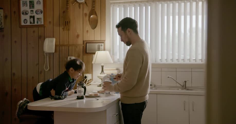 A man and his kid in a kitchen making food