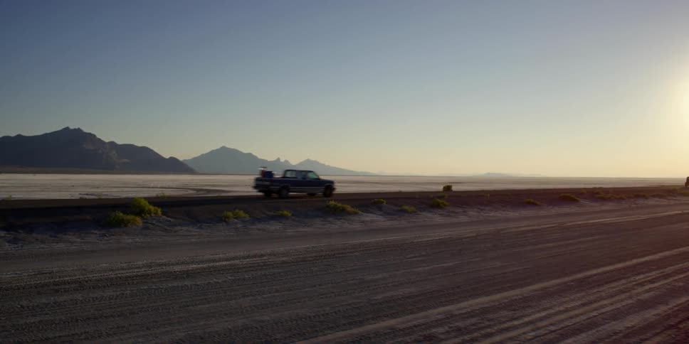 Vehicles travel down a desert road