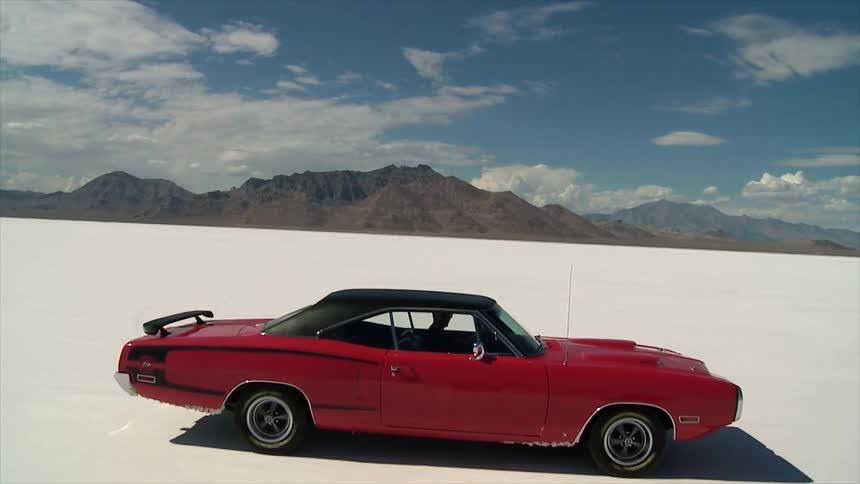 Car drives across a salt flat