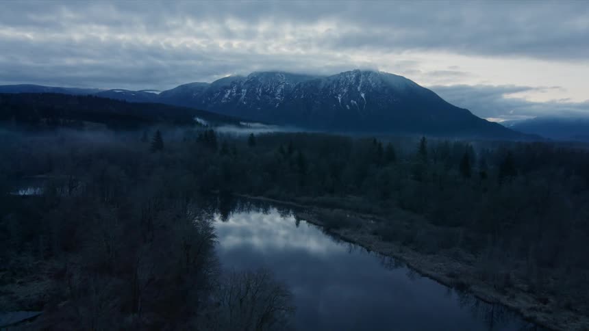 Gray clouds hang above the hills and mountain
