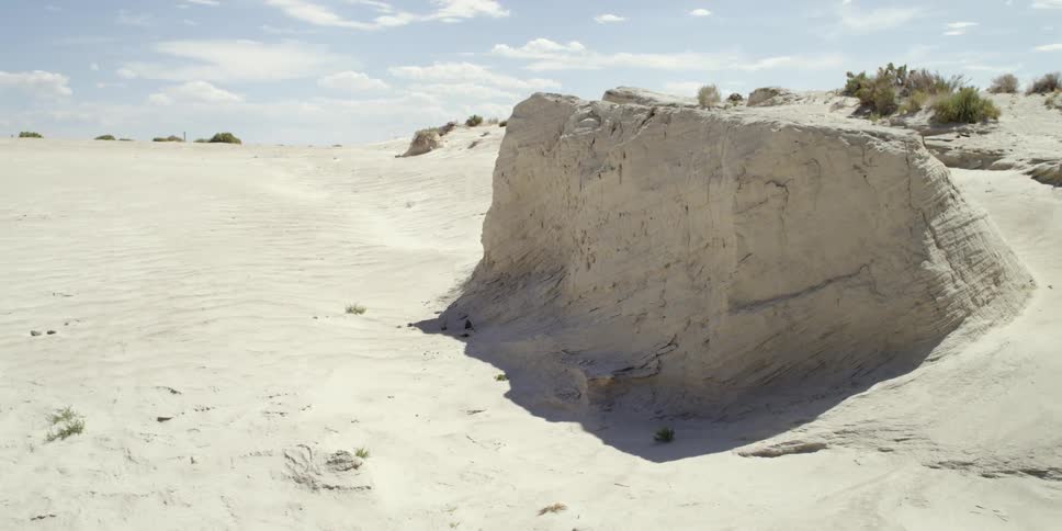 The beach has a hill leading up to the exit