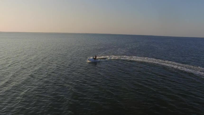 A boat drives and makes a turn in the water