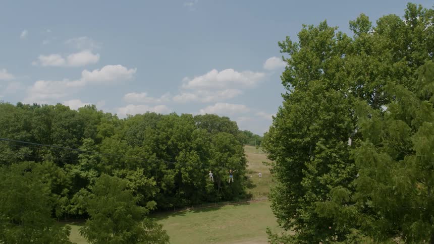 People ride a zip line at high speed