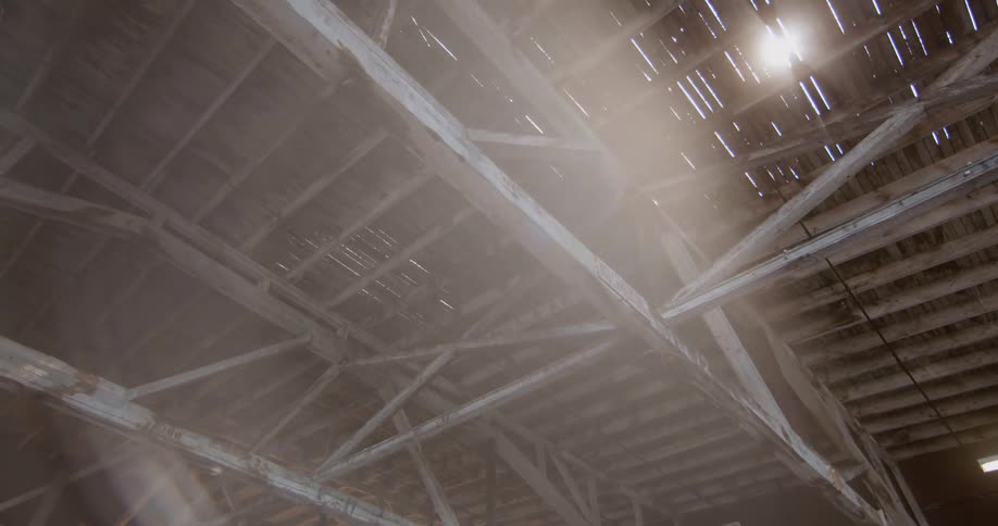 The sun is peeking in through the damaged roof above