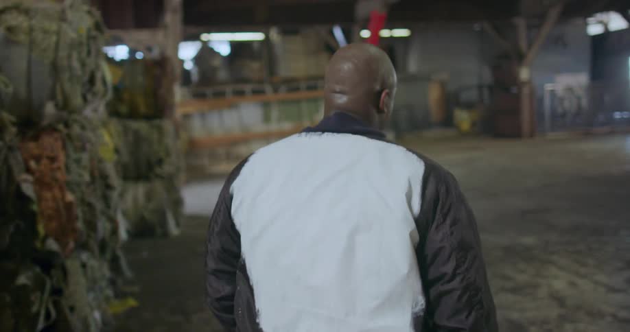 A man is walking through a factory