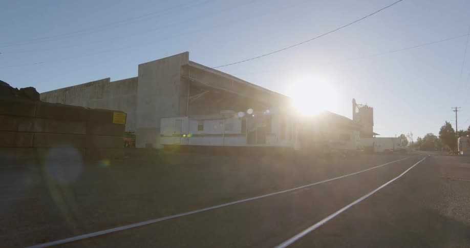 The sun shines over a concrete building