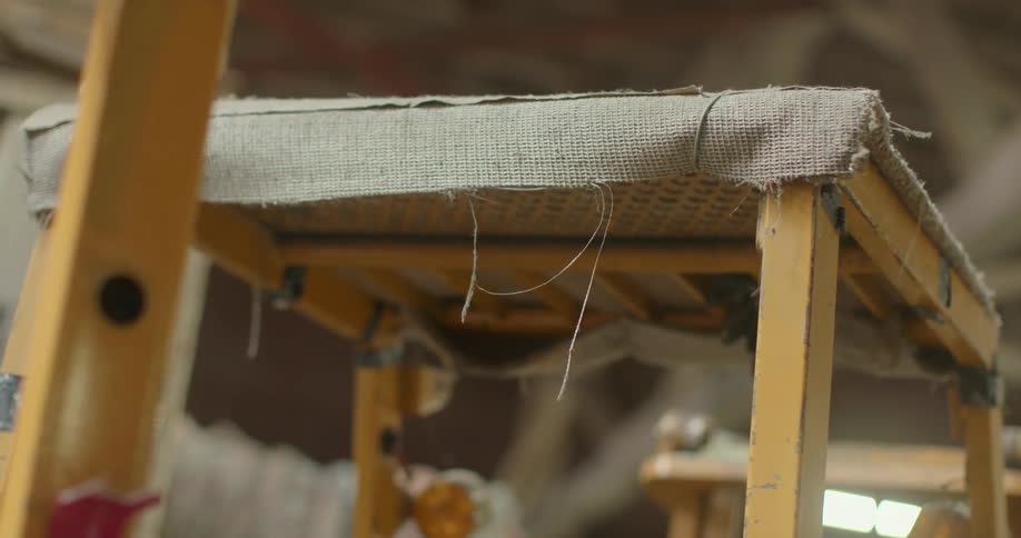 Loose fabric hangs off of a piece of furniture
