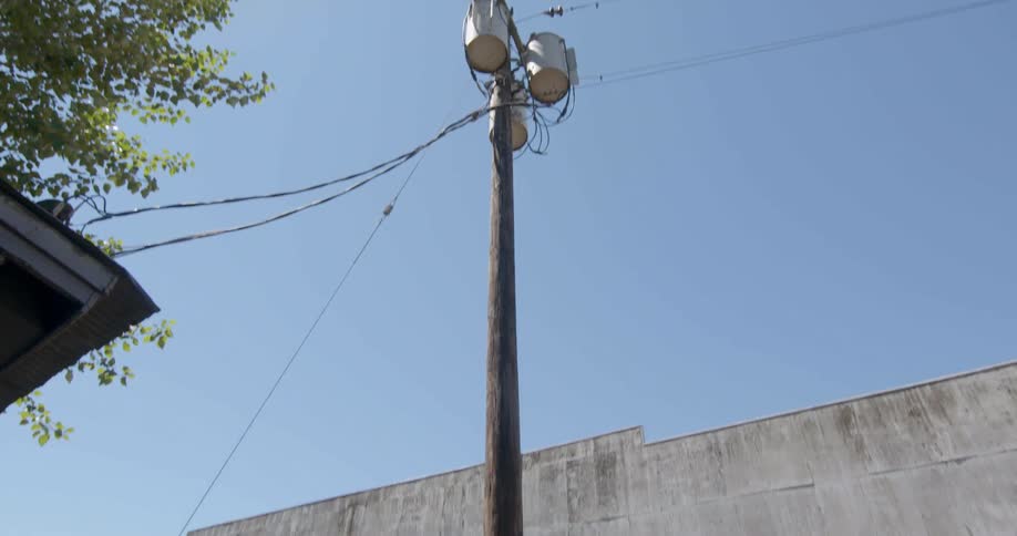 The power pole is right next to the house