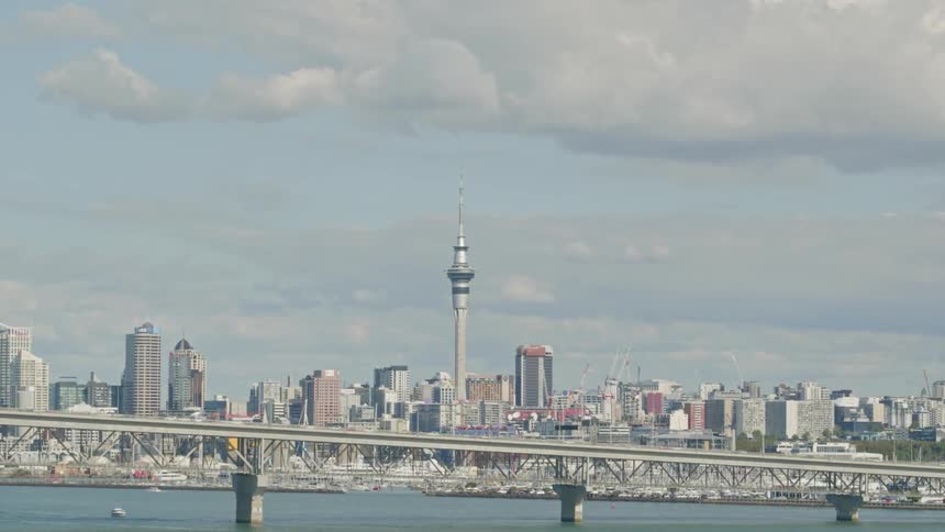 Vehicles travel over a bridge into and out of the city