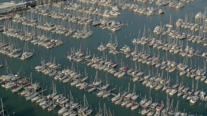 Numerous boats sit docked in a harbor