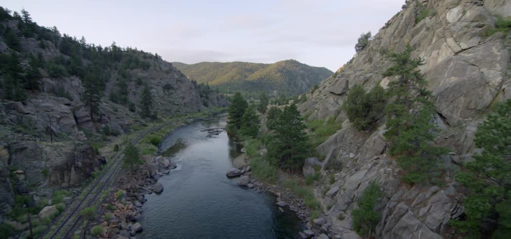 A small river is nestled between two hills