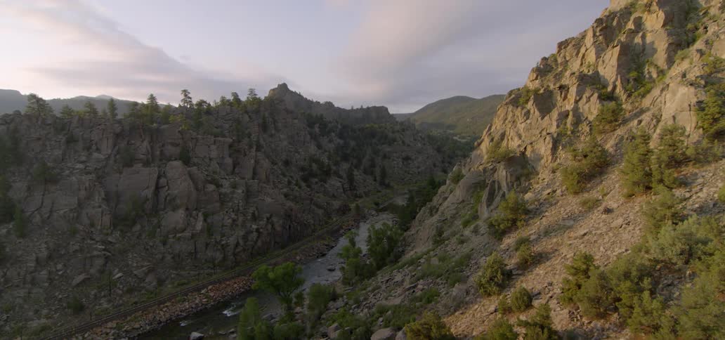 A river runs between two rocky hills