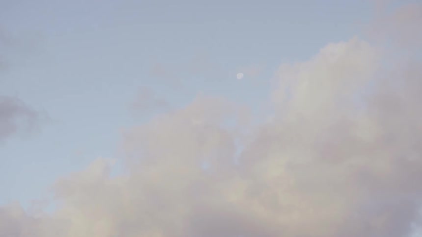 The moon and clouds in a blue sky