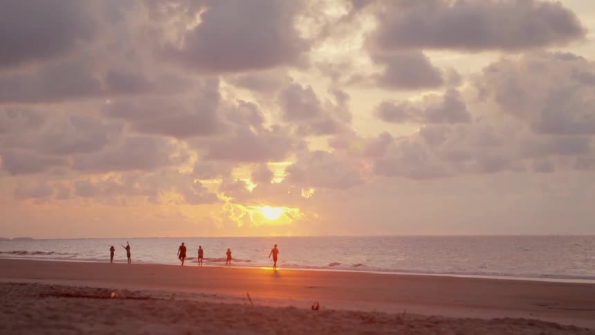 People walk on the beach shore