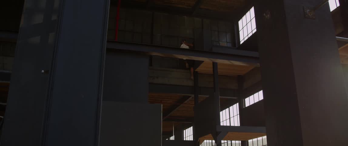 Man jumping from ledge to ledge in an indoor obstacle course