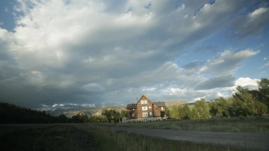 View of a single house near a forest on a cloudy day