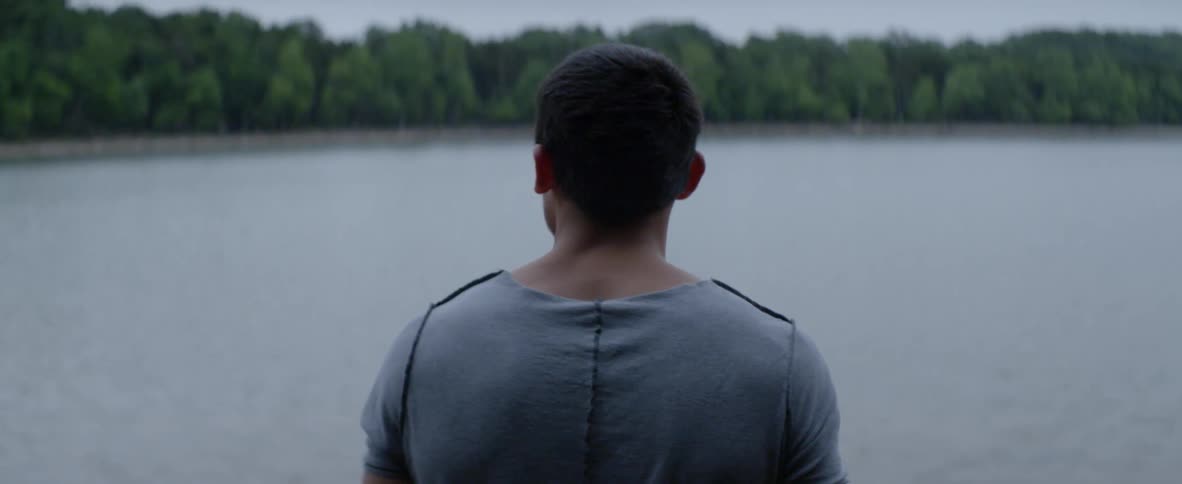 A man walks into a lake