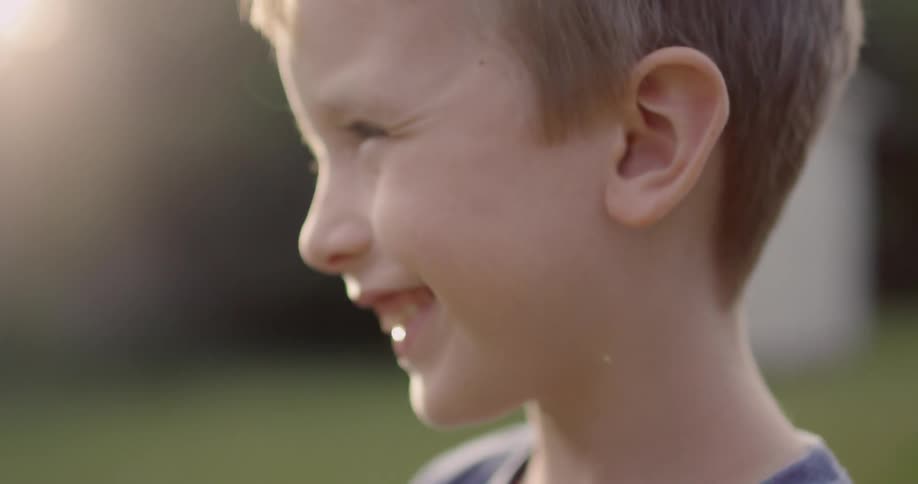 Boy smiles and laughs on a sunny day