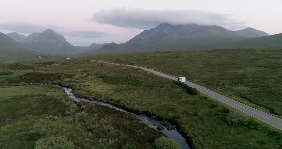 Truck travels across a valley floor highway