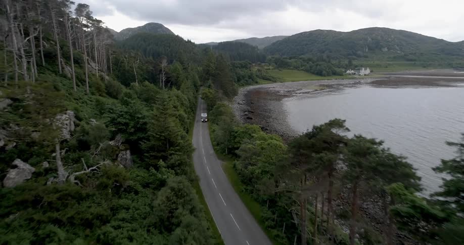 A truck drives on a lakeside street