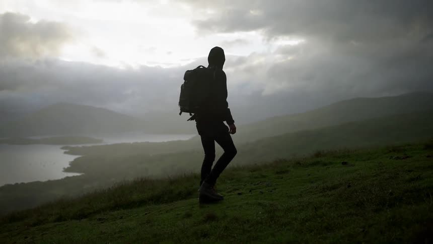A hiker climbs up a hill