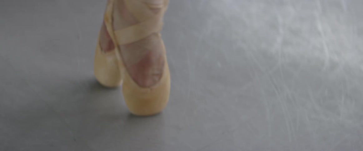 A ballet dancer balances on her toes