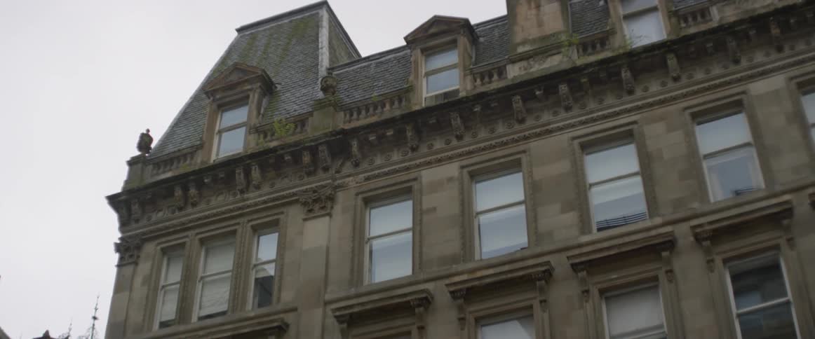 An ornate building is viewed from ground level