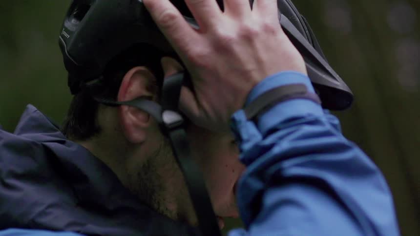 Man puts bicycle helmet on his head