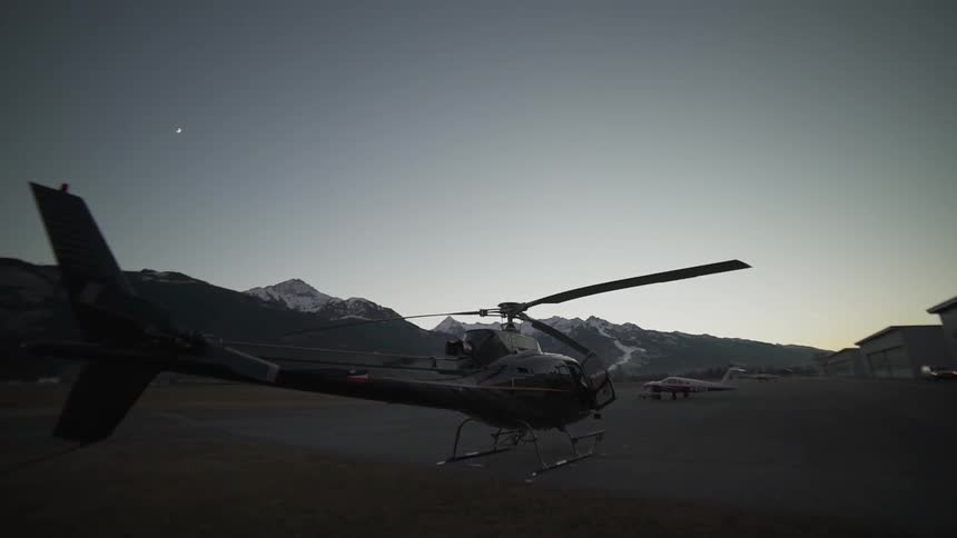 A man exits the cockpit of a helicopter