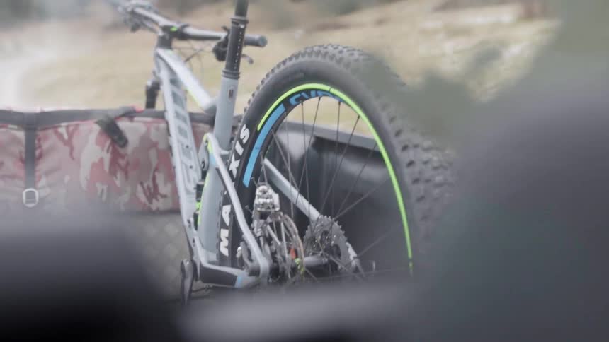 A truck hauls a bicycle in the bed