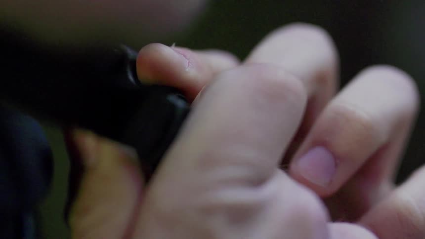 Persons fingers clipping a helmet strap in