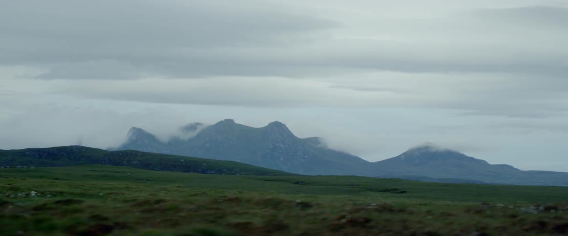 Grassy plains and cloud covered hills