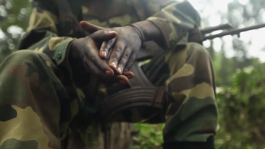 Soldier is seated with his hands together