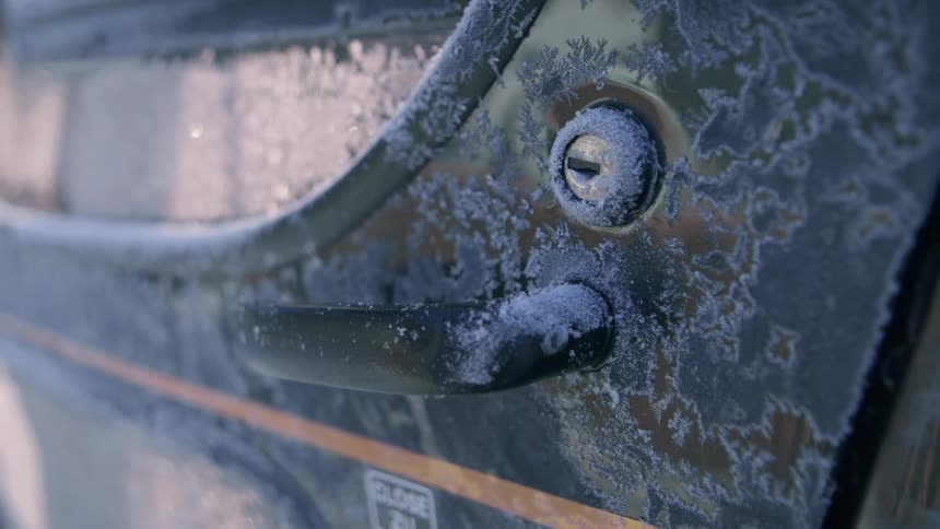 The door of a helicopter is covered in frost
