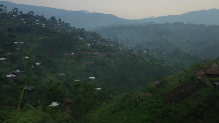 Small buildings are scattered on a hillside