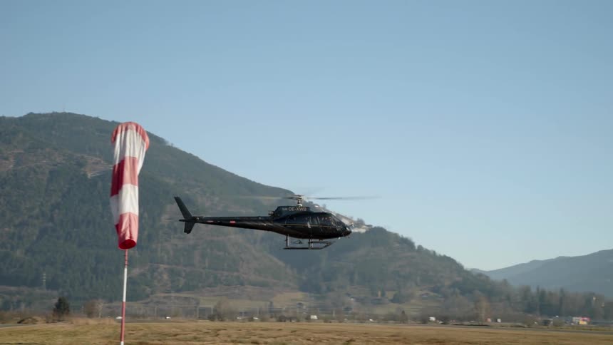 A helicopter is flying low to the ground