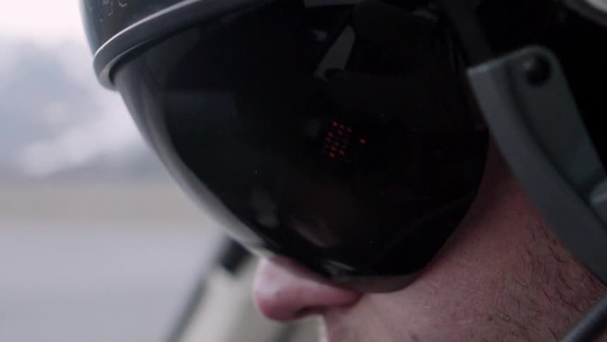 A man puts down his visor